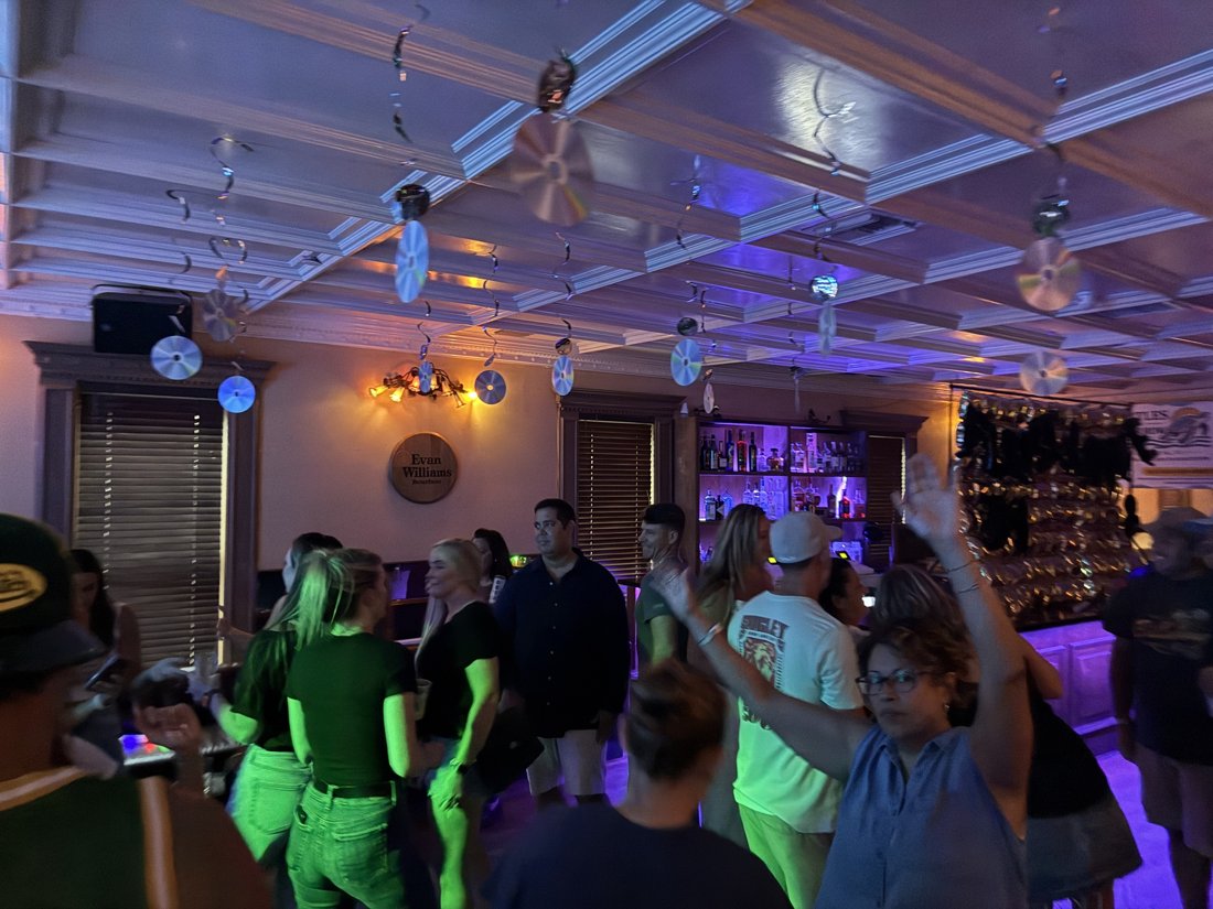 Crowd dancing under the disco lights